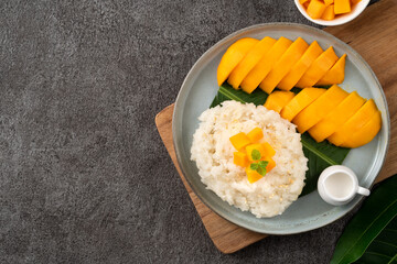 Delicious Thai mango sticky rice with cut fresh mango fruit in a plate.