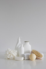 Сomposition with bath accessories, cosmetic bottles, massage brush, sponge with soap and towel