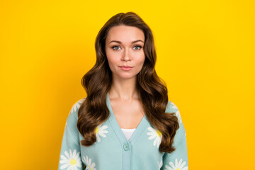 Obraz premium Portrait of focused concentrated pretty girl calm serious face nice hairdress isolated on yellow color background