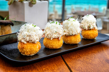 Exquisitely presented cheese balls topped with a creamy white cheese.