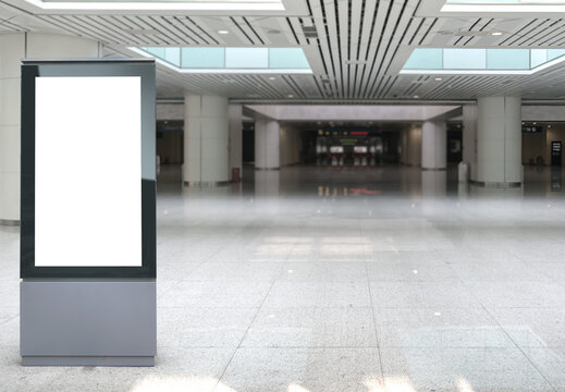 Beautiful blank advertising billboard at airport, train station. White panel for mockup. Copy space background, large LCD advertisement.