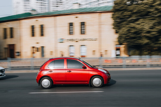 Ukraine, Kyiv - 16 Jule 2021: Red Nissan Micra car moving on the street. Editorial