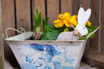 Spring pot with flowers and bunny. Spring garden decor.