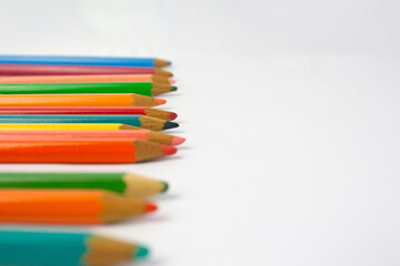 Numerous colored pencils dropped to the left of the image