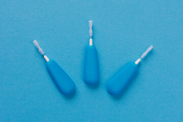 Top view of little dental toothpick brush on blue background