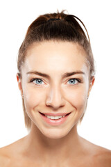 Obraz premium Beautiful girl with blue eyes close up beauty portrait. Smiling and looking at camera.