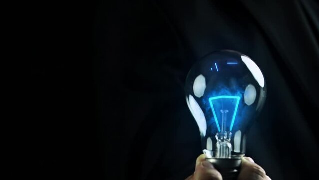 Businessman shows AI icon in light bulb, AI artificial intelligence, chat bot, machine learning concept, big data, cloud computing, computer network and futuristic innovation technology.