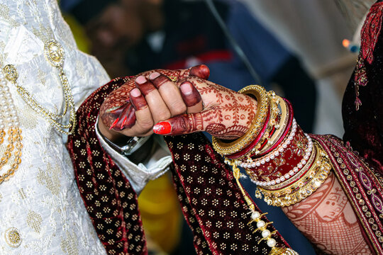 Indian wedding party, Closeup of Indian Hindu couple holding each other hands during marriage symbolizing love togetherness and promise