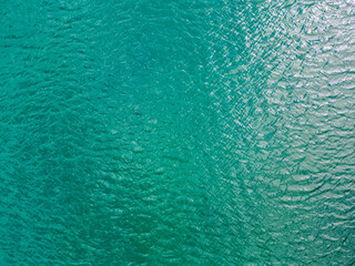 Aerial view of a crystal clear sea water texture. View from above Natural blue background. Blue water reflection. Blue ocean wave. Summer sea. Drone. Top view. High quality photo