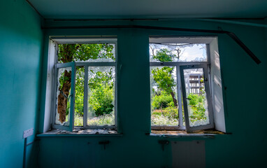empty window of a destroyed house in Ukraine