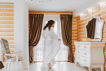The bride in her stylish room, preparing for the wedding. A girl in a dressing gown