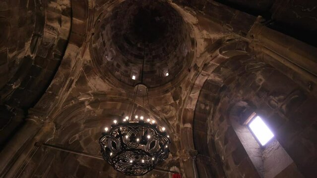 GEGHARD, ARMENIA - JUNE 6, 2023: Inside Geghard Temple. Interior of famous Geghard Monastery and church carved into rock