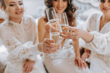 The bride and her girlfriends are celebrating their wedding day in the room. The girl the evening before the wedding. Glasses close-up