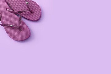 vacation and summer image with purple flipflops over pastel background