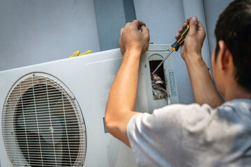 The electrician repairing the air conditioner, Technician is checking the coolness air compressor