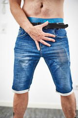 Male holding hand in front of waist