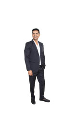 Smiling handsome young indian businessman wearing suit standing looking at camera isolated over white background. Corporate Concept.