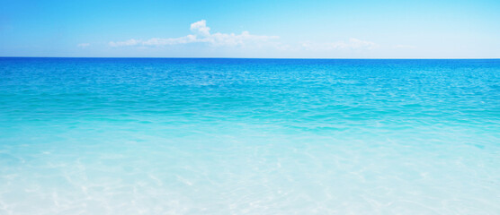 Fototapeta na wymiar Idyllic sand beach, tranquil sea, and blue sky create a serene summer vacation destination.