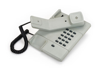 Grey vintage off-hook telephone from the eighties isolated on completely white background