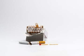 Smoking cessation concept.  Open pack of cigarettes with one cigarette broken in half.