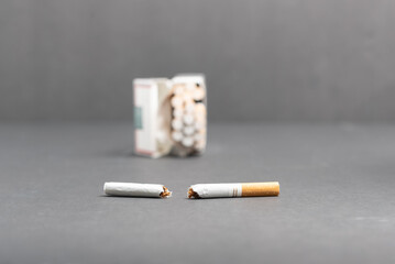 Smoking cessation concept.  Open pack of cigarettes with one cigarette broken in half.