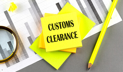 CUSTOMS CLEARANCE text on sticky on chart with pencil