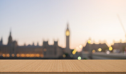 abstract blurred sunset skyline hour at Bigben tower in house of parliament with Thames river and bridge landmarks in London city  and wood table for show and promote ads or content on display concept - obrazy, fototapety, plakaty