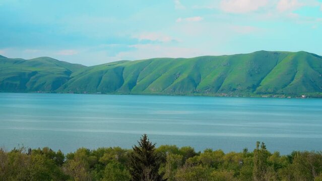 Fantastic evening panorama of alpine Lake Sevan in Armenia. Panoramic view of mountain lake in front of mountain range, national parks of Armenia .