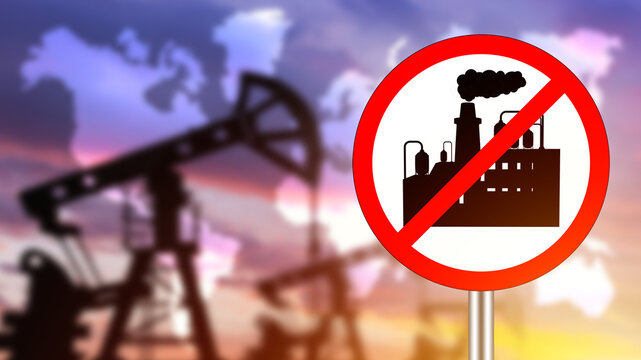 Sign with crossed out factory. Oil refining industry. Signboard prohibiting oil production. Concept of collapse of oil refining industry. Mining pumps are blurred. Gasoline fuel prohibition. 3d image