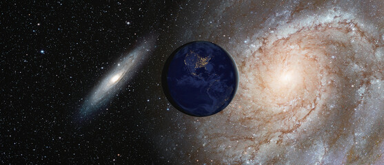View of Earth from outer space with millions of stars around it - Andromeda galaxy against Our...