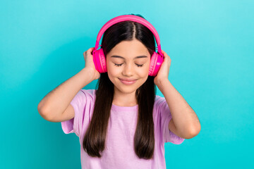Photo of young funky girl brunette hair wear pink t-shirt listen music stereo sound high quality itunes isolated on blue color background