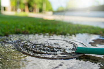 Water flowing from garden hose in summer.