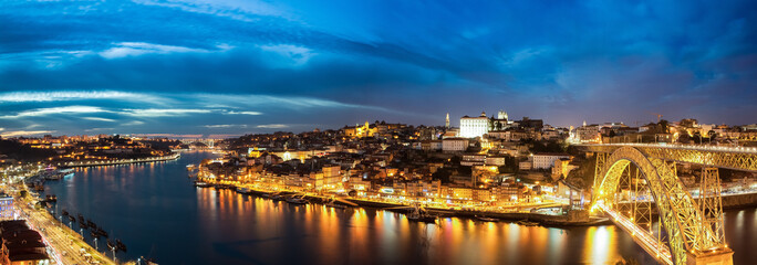 Porto, Portugal. Panoramic cityscape image of Porto, Portugal with the famous Luis I Bridge and the Douro River during dramatic sunset.