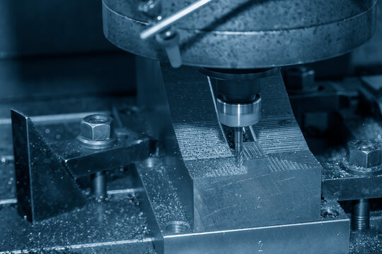 The CNC milling machine cutting press part with ball end mill tool.