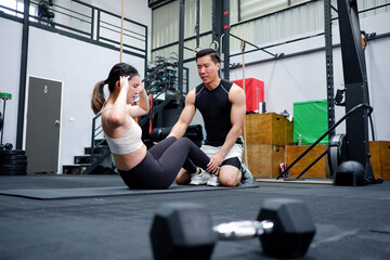 Young man and woman exercising in the gym fitness concept look and be healthy.