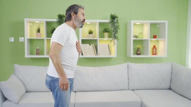 Mature man having heart attack at home.