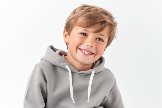 smiling little boy in grey hoodie looking at camera isolated on white