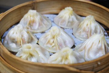 several Chinese Tangbao (soup buns) in bamboo steamer. soup-filled steamed buns (baozi) in China