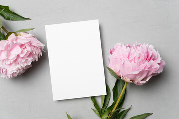 Invitation or greeting card mockup with peony flowers, flat lay with copy space