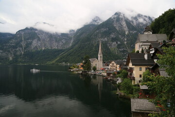 Fototapeta premium A view of a town with a lake and mountains in the background, Austria