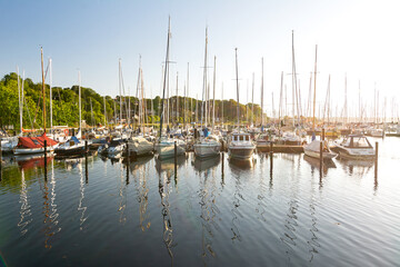 Sailing boats in a marina (Fahrensodde) during sunset at the Baltic Sea in Northern Germany