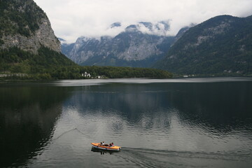 A man peacefully rowing a small boat on a lake, Austria