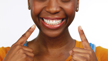 Happy isolated African American female smiling for tooth, mouth or gum and oral hygiene. Black woman, teeth and smile for dental care, whitening or healthcare against a white studio background.