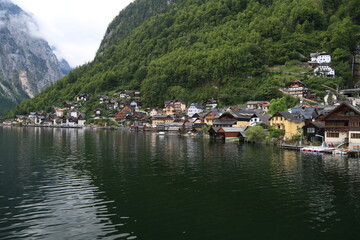 Fototapeta na wymiar Photo of a serene lakeside town with colorful buildings and boats on the water, Austria