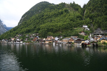 Fototapeta na wymiar Photo of a serene lakeside town with colorful buildings and boats on the water, Austria