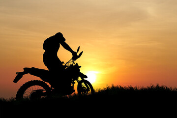 Man with motocross bike against beautiful lights