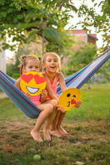 Fototapeta na wymiar Children demonstrate paper-cut emoticons on World Emoji Day