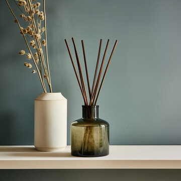 Reed diffuser bottle mockup, aroma diffuser in luxurious beige and brown home interior decor, front view
