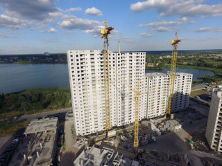 Aerial view of construction site of residential area buildings with cranes. Kiev, Ukraine