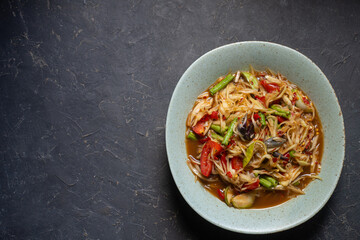 Som Tam Thai - Papaya Salad Thai Food Style on wooden table background.Top View